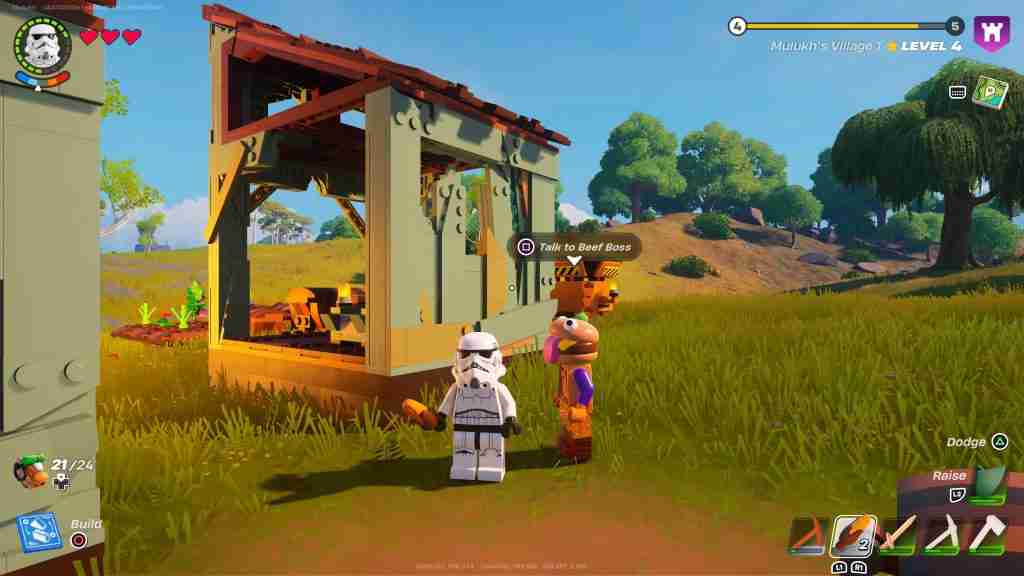 Lego versions of a Star Wars Stormtrooper and a Fortnite character with a burger for a head stand next to a Lego shack in a more realistic grassy field