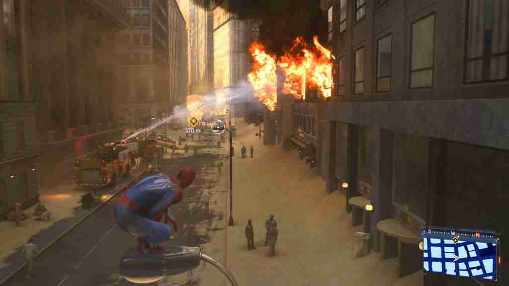 spider-man in blue and red suit watches firefighters tackle a fire from the top of a lamp post