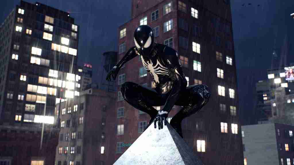 spider man in a black and white symbiote suit crouched on a spire with a night time city behind him