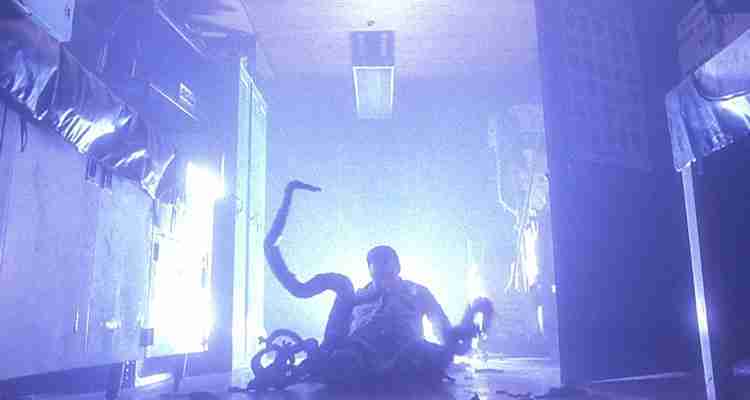 Scene from Phantoms (1998) a police officers lower body has transformed into tentacles