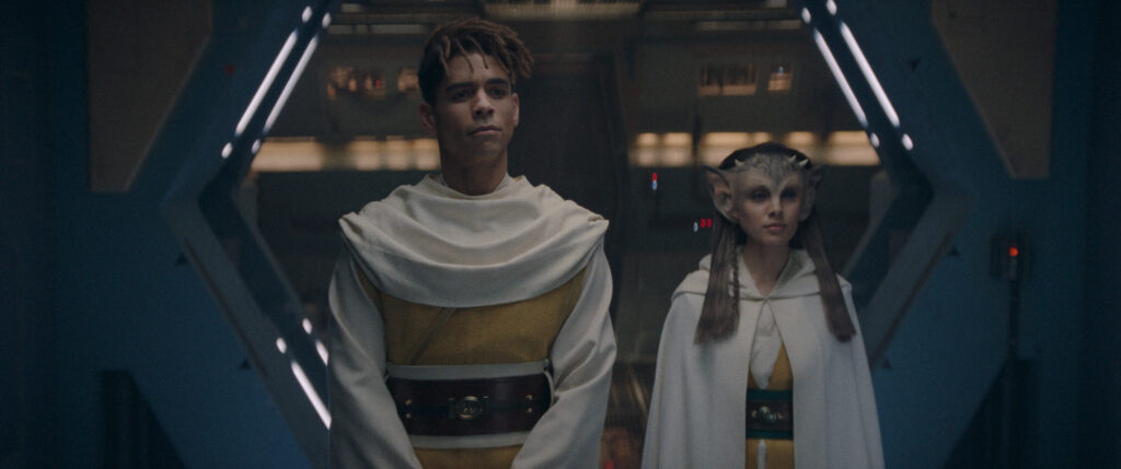 Yord and his alien Padawan stand side by side, dressed in yellow and white robes - The Acolyte