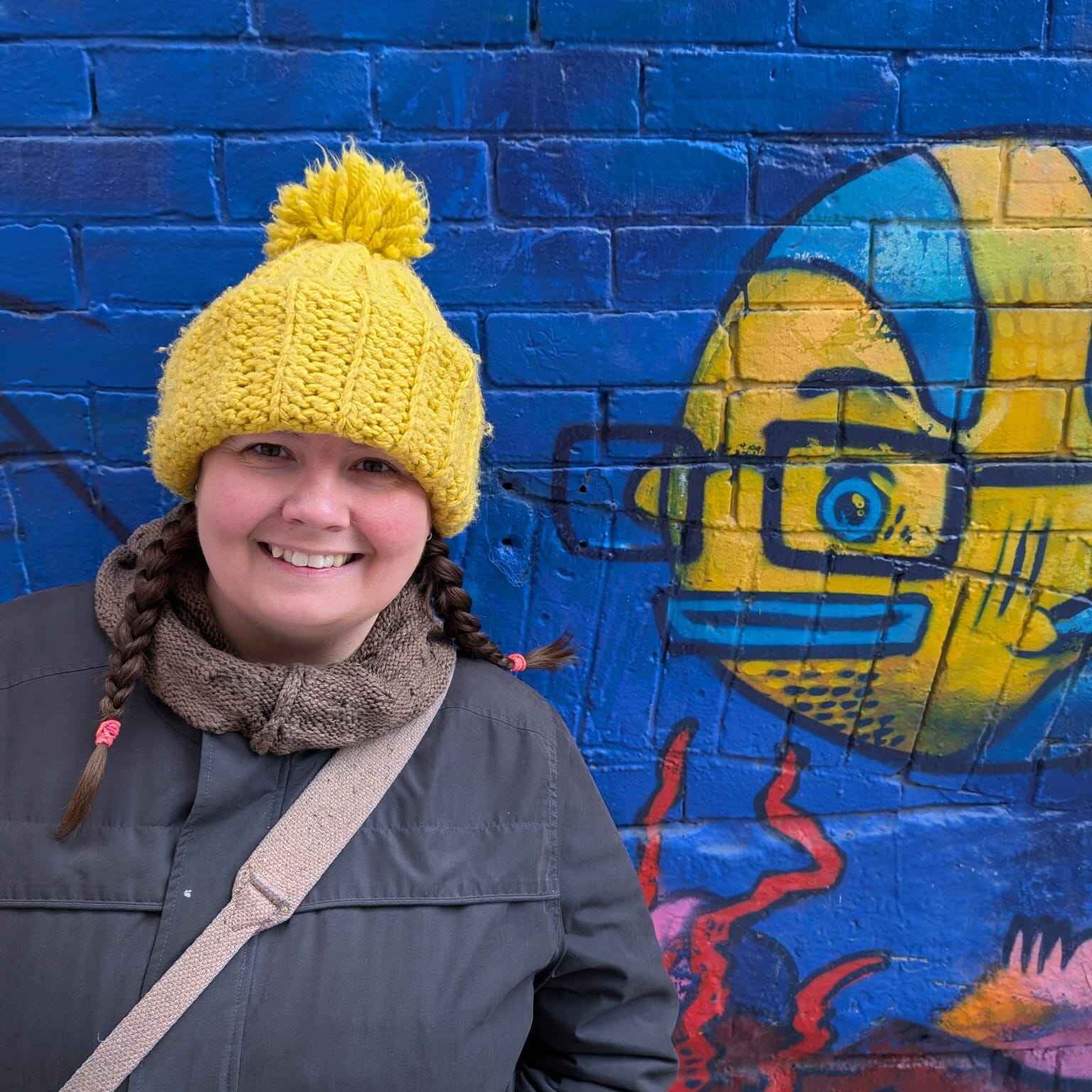 Author Mandy S Knight  with a yellow hat with a yellow fish graffiti