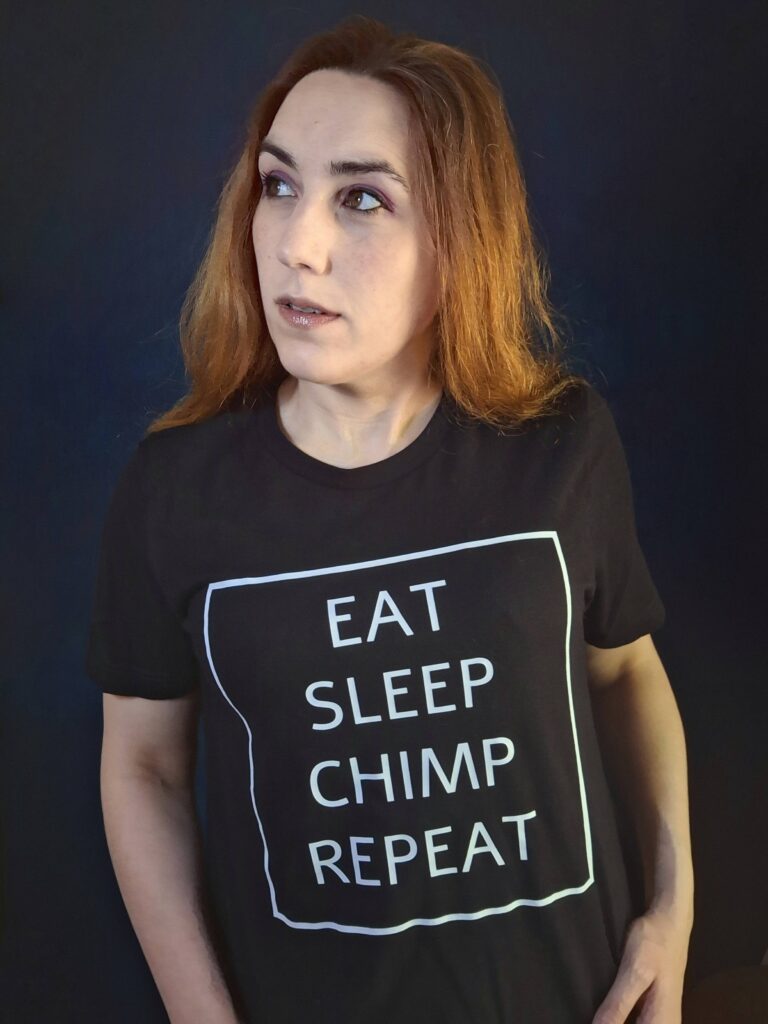 TYG Merch Mashashy wearing the Eat Sleep Chimp Repeat shirt in black