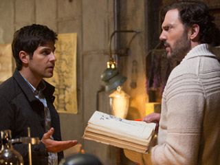 Left to right Nick Burkhardt and Monroe, look at an old book - Grimm