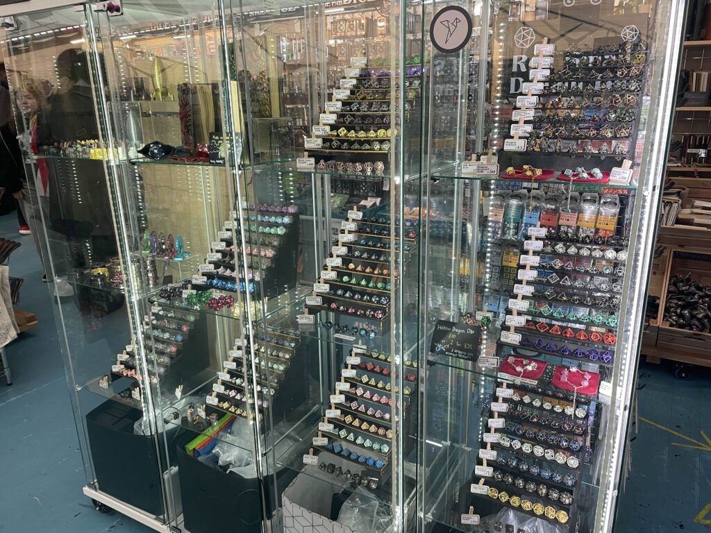A display shelf of many, many rpg dice - Comic Con 25