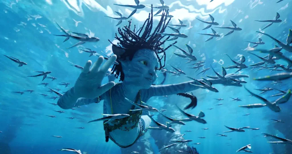Tuk underwater watching fish swim by - Avatar: The Way of Water