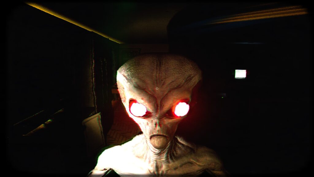 UFOPHILIA - A dark room showing a kitchen to the left and a white TV screen to the right. At the front centre of the screen is an alien from the shoulders up, staring forwards, its eyes red and mouth turned downwards.