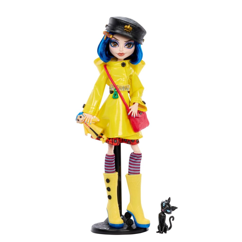 The Coraline doll standing proudly with her kitty companion