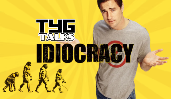 Yellow background with sun rays, a man to the right with a quizzical expression, arms raised outwards to his side, wearing a grey t-shirt with a red circle, the evolution of man in the bottom left corner, the name Idiocracy in the centre and TYG Talks logo just above the title to its right.