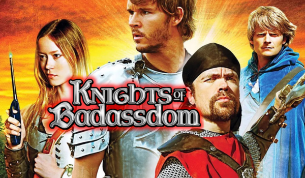 A fiery orange and yellow background behind four people dressed in medieval clothing. A firelighter in the hand of the left most person, all people looking away in different directions. The title of the Film "knights of Badassdom" at it's centre left.