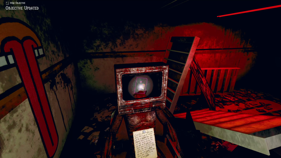 an exploded tv in a bloodied room. the outline of a cassette tape can be seen inside. a note is lying in front of the tv